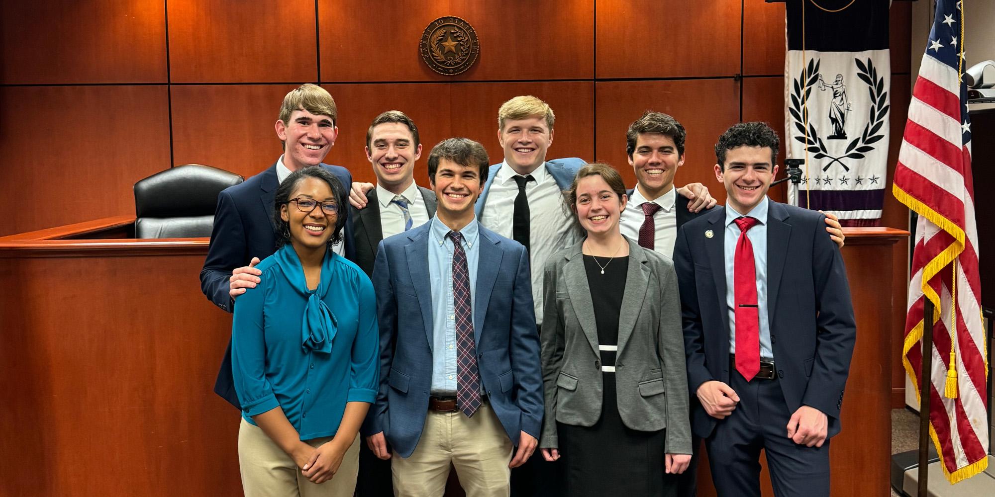 Benedictine College's 2023 moot court team poses for a photo in a courtroom