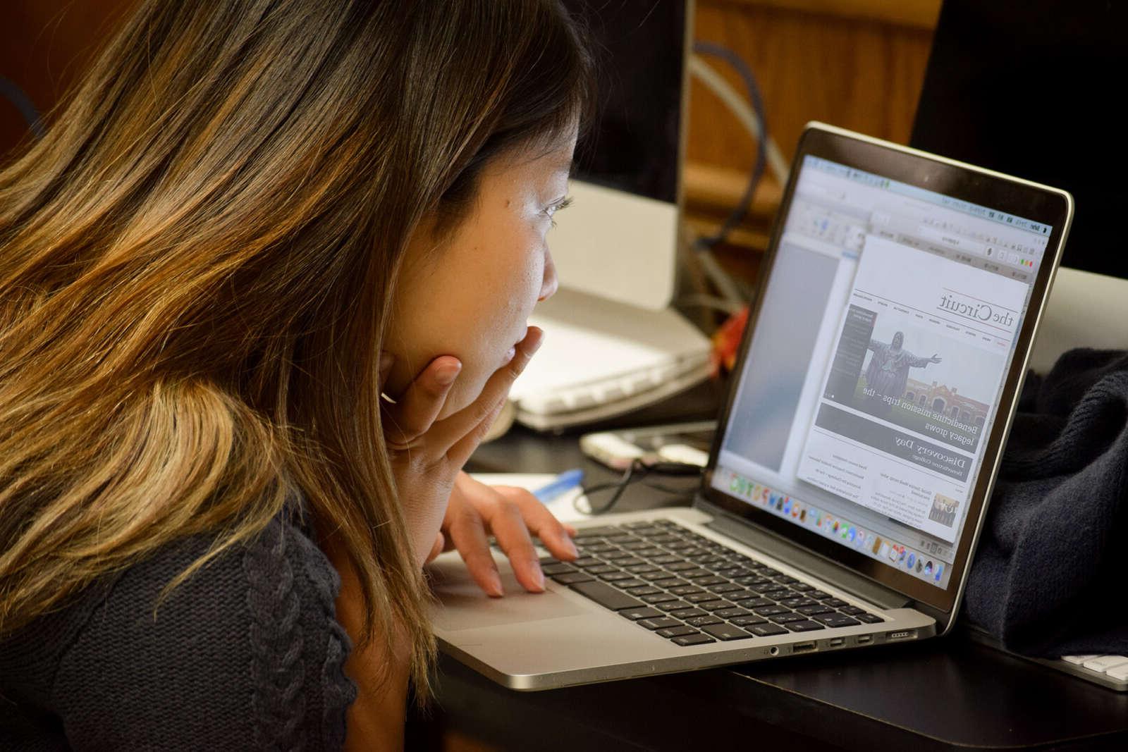 student working on the school newspaper